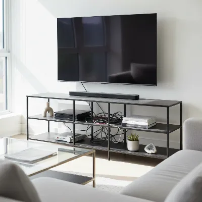 A modern living room with an open shelving TV stand showcasing electronics and decor, but also a slight hint of visible cables and dust on the shelves, highlighting the pros and cons.