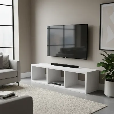 A simple, modern DIY TV stand made from plywood, painted white, with open shelves for media devices and hidden cable management through the back panel. 