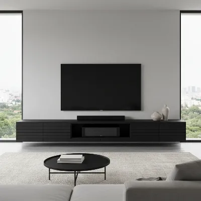 A sleek, minimalist TV console in a modern living room, with a soundbar perfectly housed within a dedicated, open-front compartment. The console has clean lines and offers additional storage, enhancing the room's contemporary feel. 